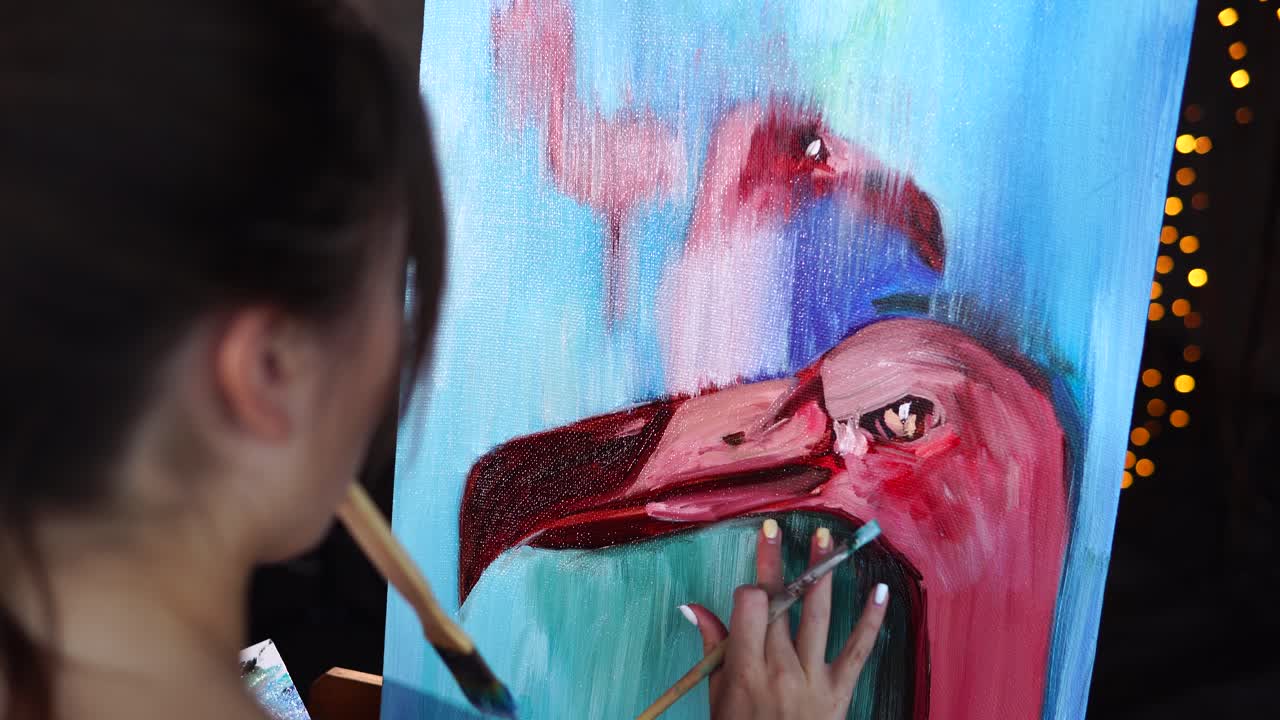 Woman painting flamingos