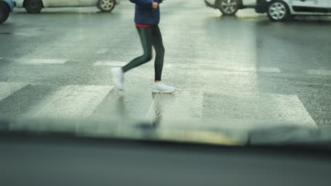 people walking across pedestrian street crossing on a a rainy day