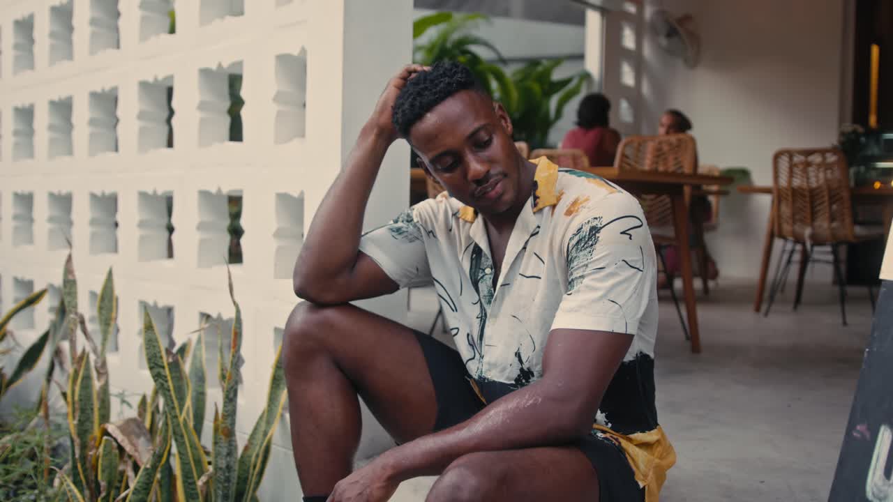 Man Sitting Outside Cafe