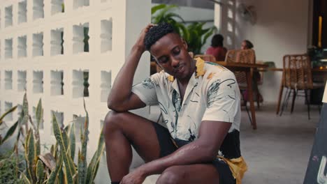 man sitting outside cafe