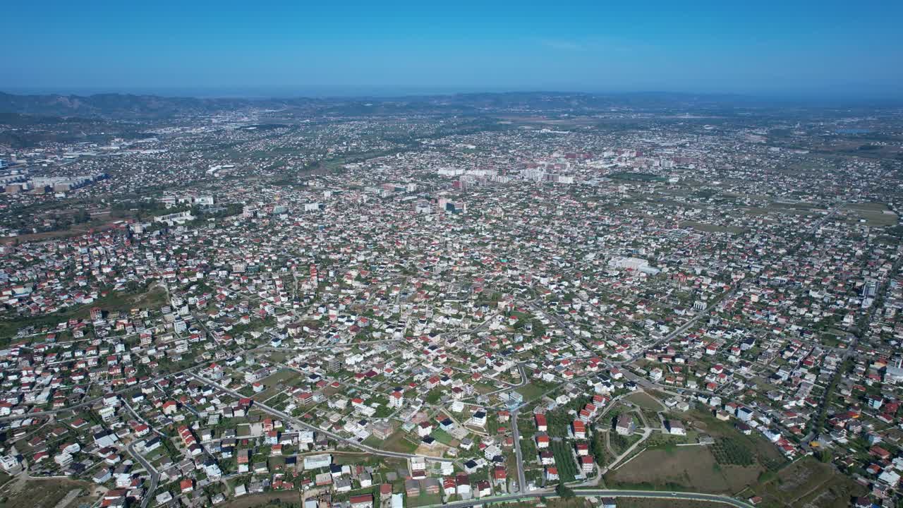 Tirana suburbs seen from above, population pressure, urban growth, demographic trends on real estate