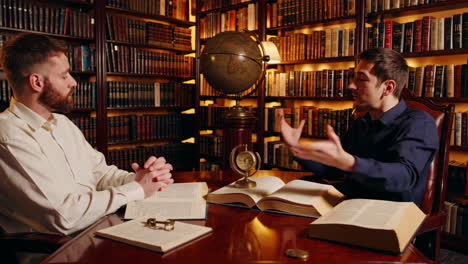 two men discussing in a library