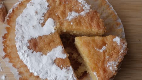 tarta de santiago with almonds on a wooden board, close-up view