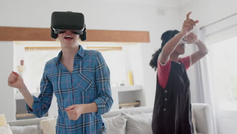 Happy-diverse-teenage-female-friends-playing-and-wearing-vr-headsets-at-home,-slow-motion