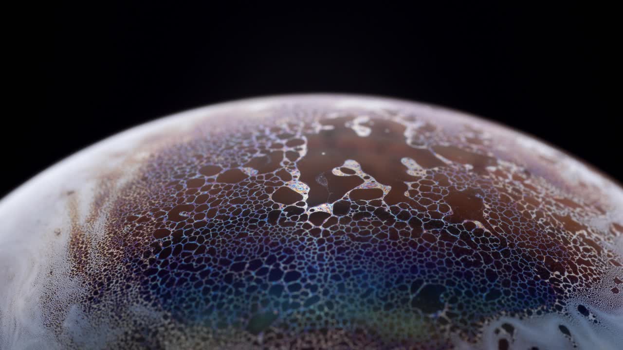 View of a distant planet's surface with vibrant colorful textures and small bubbles