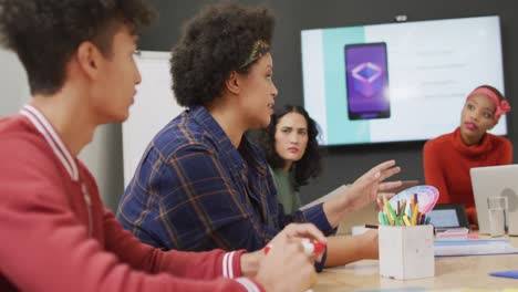 happy diverse business people discussing work during meeting at office