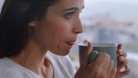 happy young woman looking out window drinking coffee enjoying fresh aroma ready for new day feeling rested