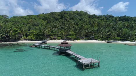 aerial orbit of gazebo on a dock out in the ocean on a perfect tropical island, koh kood, thailand