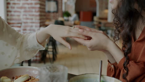 couple exchange ring in restaurant