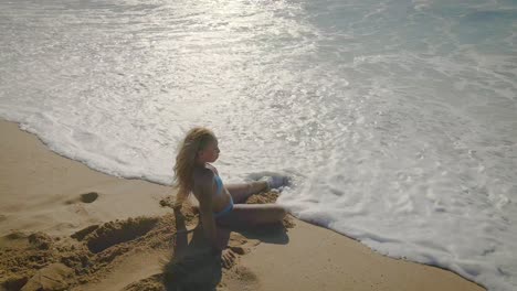 beachside tranquillity: young woman in the blue bikini finds joy in the simplicity of beach resting, showcasing the essence of travel and tourism in this tropical place