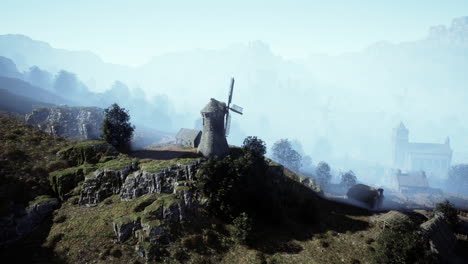 misty mountain village with windmill