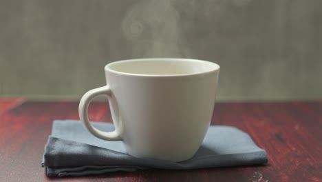 a freshly made vanilla latte sits in a white mug on the table, its creamy surface gently swirling with warmth.