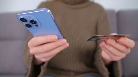 woman making money transfer with credit card and mobile phone app. female using modern smartphone for online payment. buyer making a purchase in internet store with debit card and cellphone