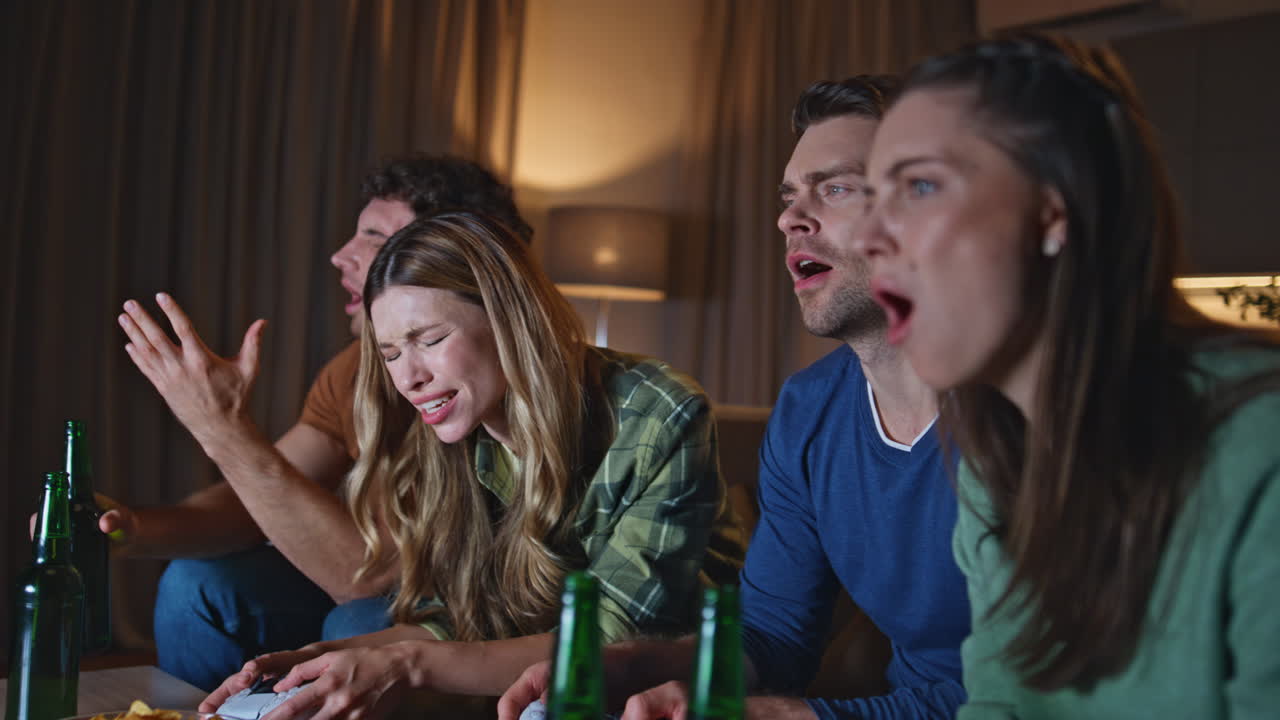 Disappointed people playing video game at evening living room close up.