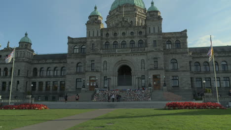 wide shot of the bc legislative assembly buildings with a memorial for indigenous children victims on the front steps in victoria bc