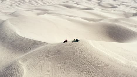 atvs on the hot imperial sand dunes with clear blue sky and sand as far as the eye can see - aerial shot