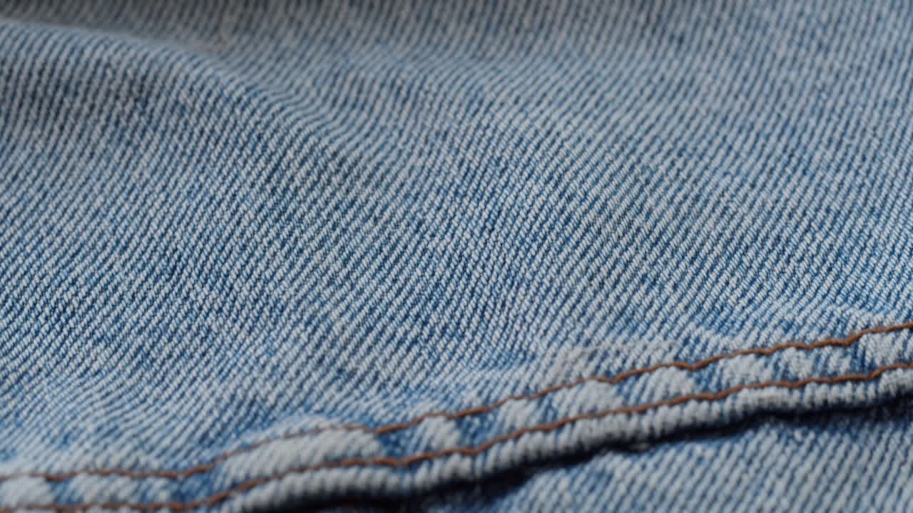 Primo piano di tessuto denim blu con dettagli di cucitura