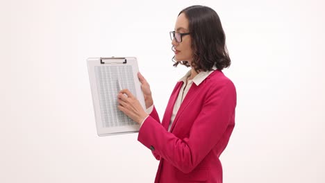 professional businesswoman in pink blazer presenting data on a clipboard