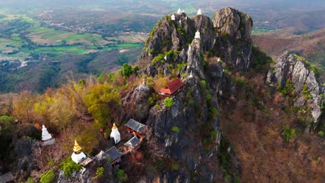 aerial drone sky temple in Lampang Thailand mountaintop pagodas of Wat Chaloem Phra Kiat aerial zoom out