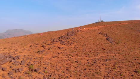 drone footage moving along a mountain revealing a landscape of rolling hills