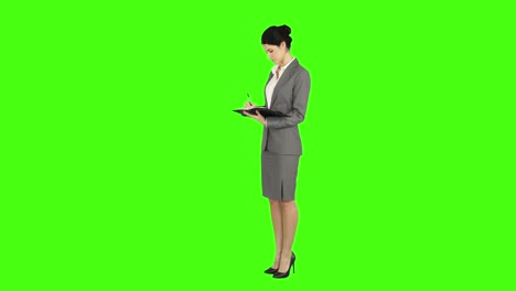 Business-woman-standing-and-taking-notes