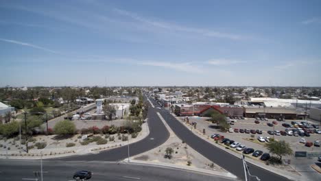 View-of-a-drone-descending-in-front-of-a-statue-in-a-rondabout