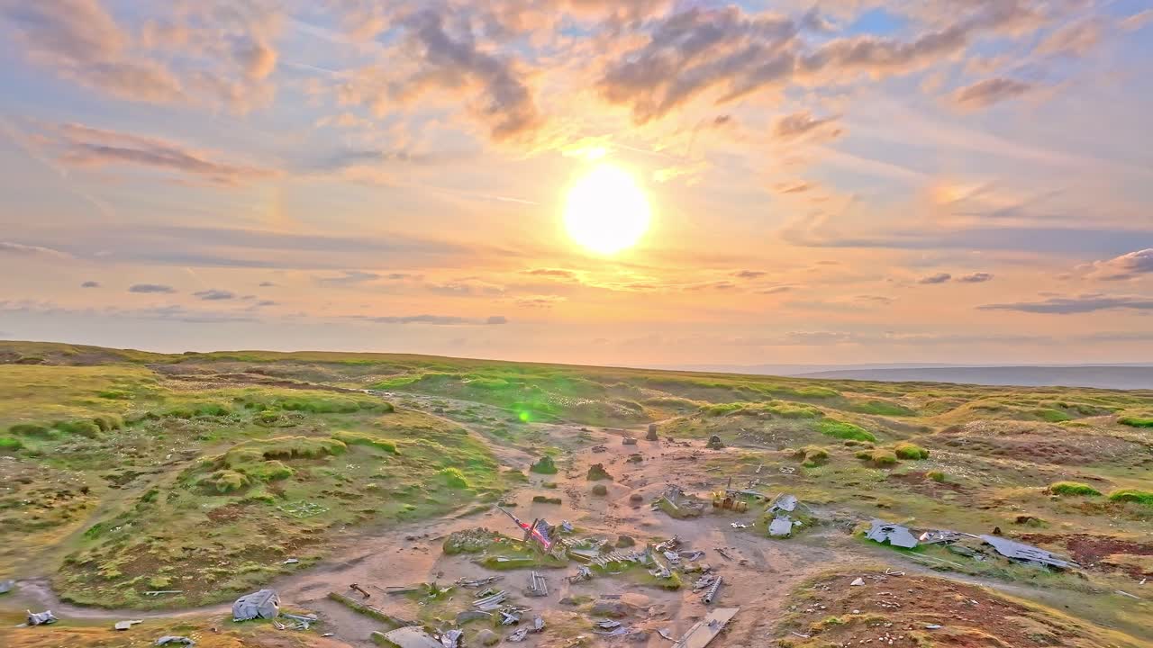 Drone footage of a B29 aircraft crash site showing the US flags in a sunset background, now serving as a US memorial. Located on Devils Dike Trail, Glossop, Peak District, UK