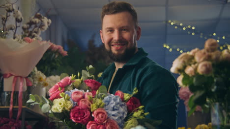 florist collects bouquet and looks at camera