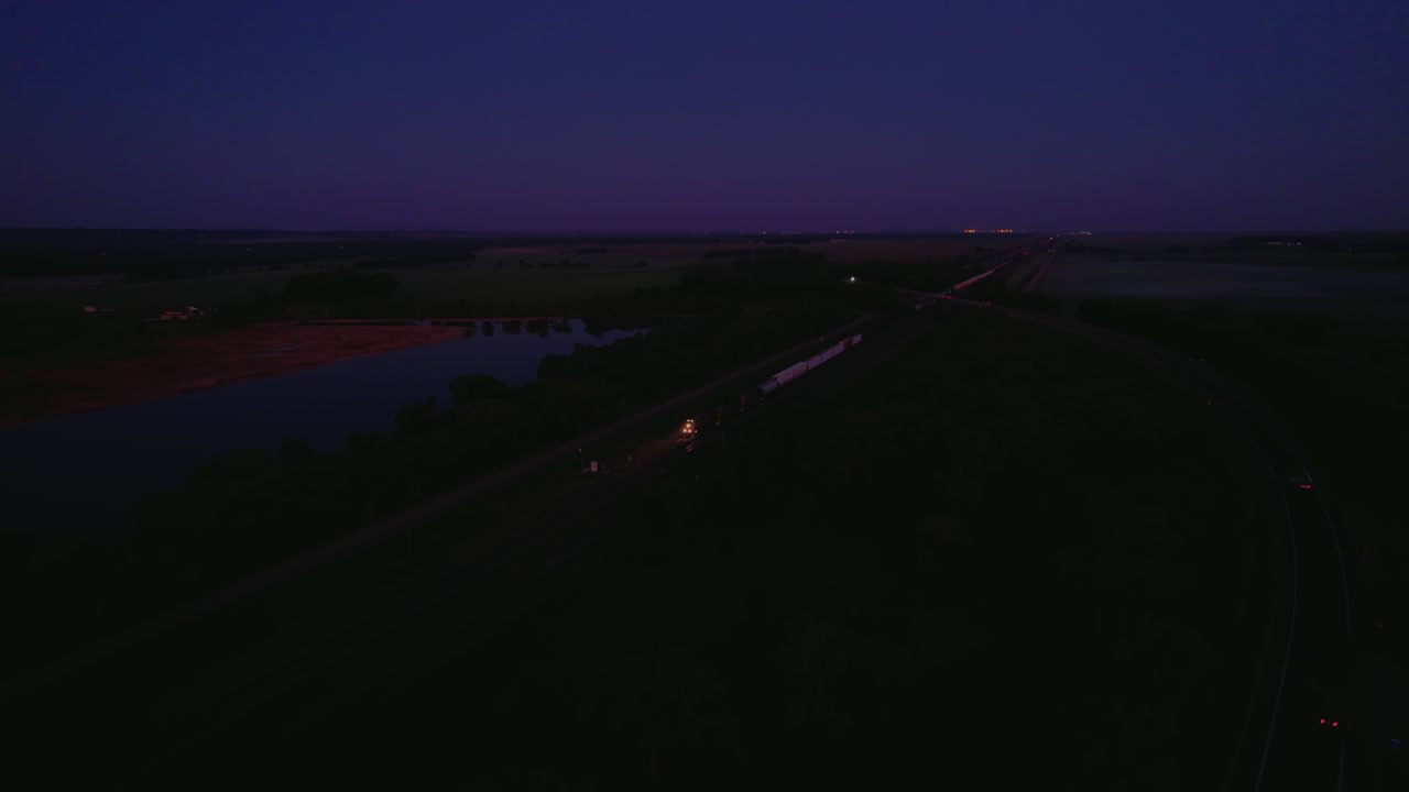 Freight Train approaching Blue hour across rural Nebraska, ideal for U.S. logistics