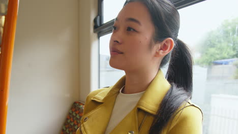 Close-Up-Of-Young-Woman-Sitting-On-Underground-Train-On-Journey-To-Work-Or-Visiting-City-2