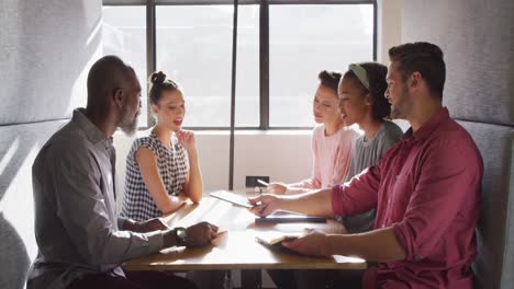 happy diverse business people discussing work during meeting at office