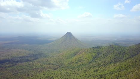 drone shot of mount kadam, the highest mountain in karamoja, uganda, rising above the surrounding landscape, showcasing the natural beauty and tranquility of the region
