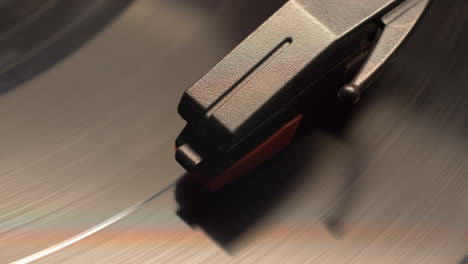 vintage style retro record player needle dropping on to a spinning vinyl music album, macro