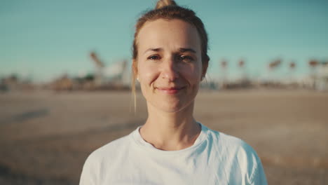 Young-sporty-woman-smiling-at-the-camera.