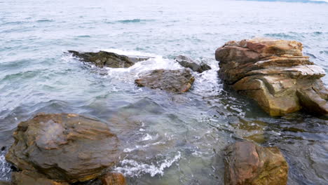 slow motion scenic landscape of nature sea wave coast to beach with stone and rock for summer vacation concept