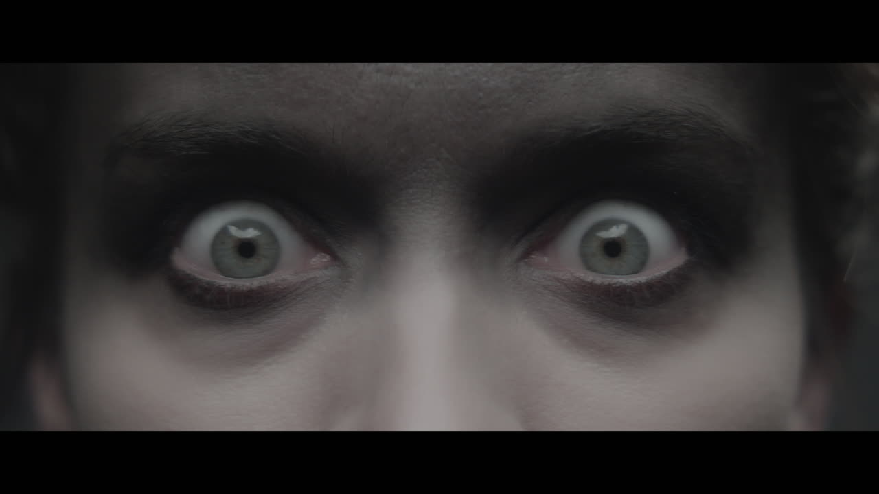 A woman dressed as mother opens her eyes wide