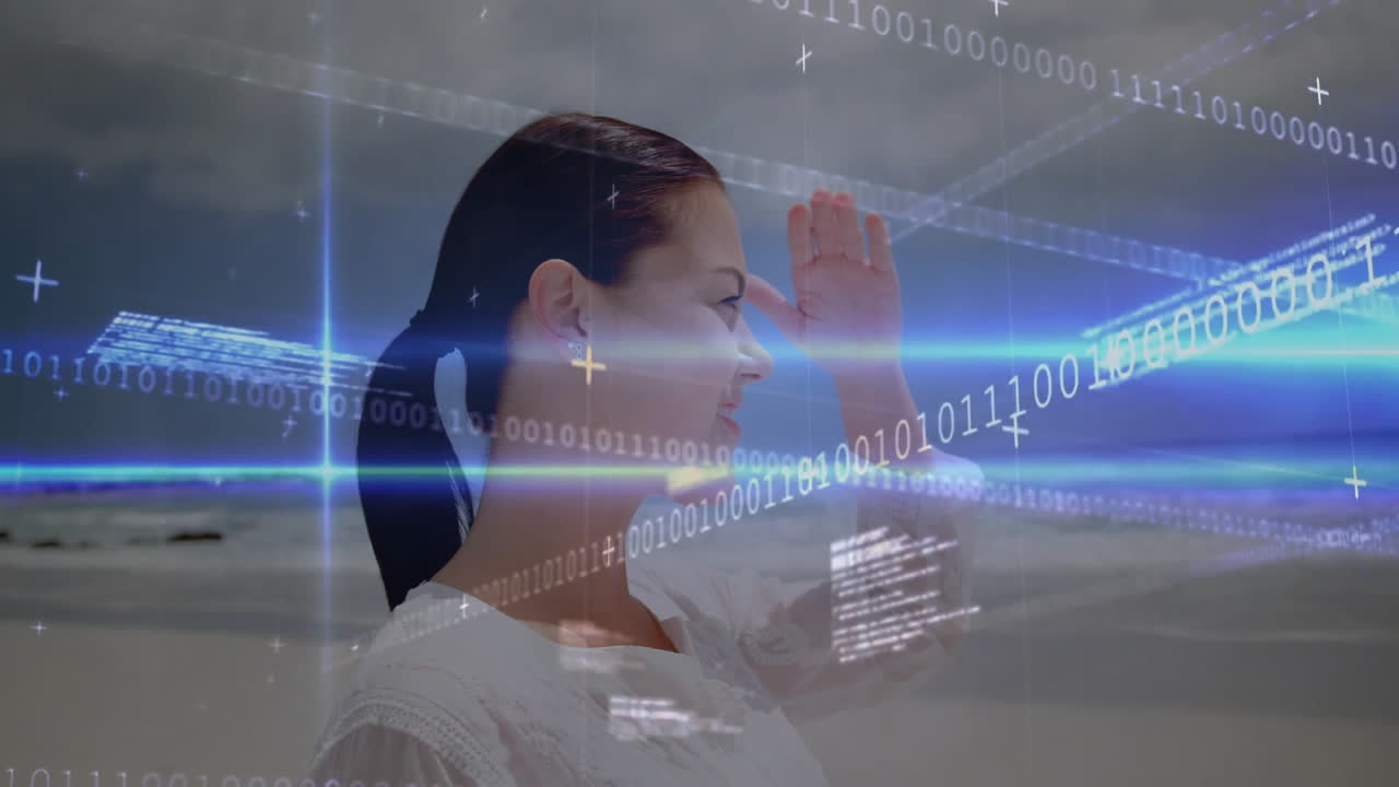 On beach, woman interacting with digital binary code and animation overlay