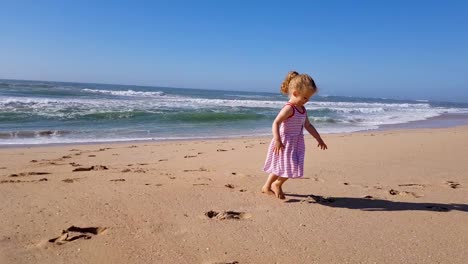 toddler girl running on the beach and having fun