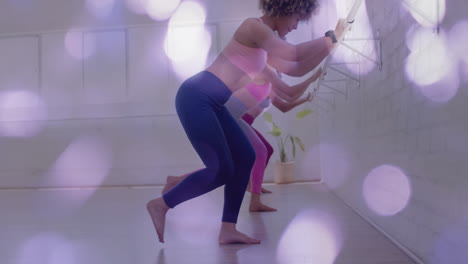 exercising in fitness studio, women stretching over bokeh lights animation