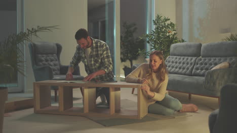 couple assembling furniture