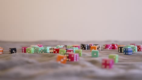 rolling blue dice onto a pile in extreme slow motion