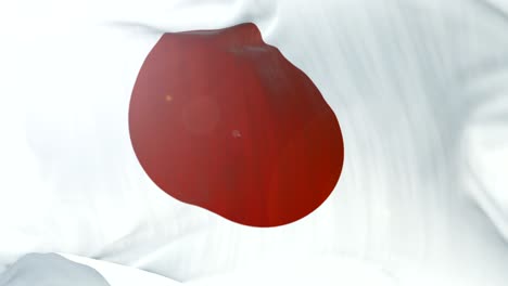 la bandera de japón se agita lentamente en el fondo. 4k agita la bandera en primer plano. bucle sin costuras