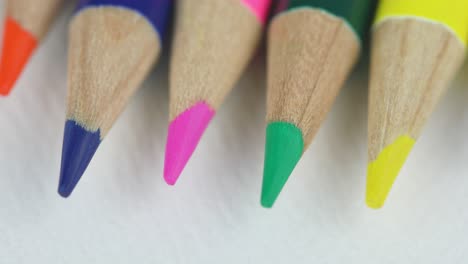 macro of sharpened colored pencils on white background