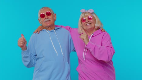 Lovely-senior-couple-man-woman-grandparents-listening-music-dancing-disco-fooling-around-having-fun