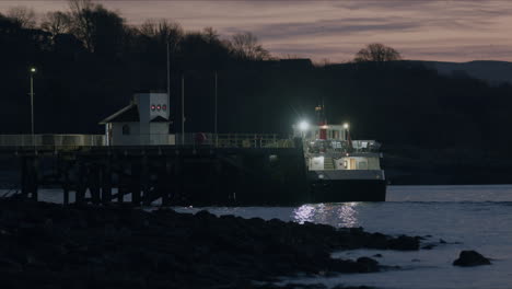 ferry boat waiting at pier in morning sunrise light, static shot