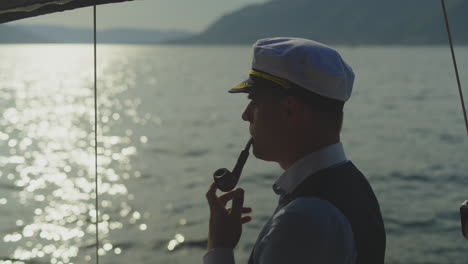 captain smoking a pipe at sea