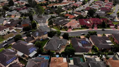 Aerial-view-of-residential-area-with-cars-driving-along