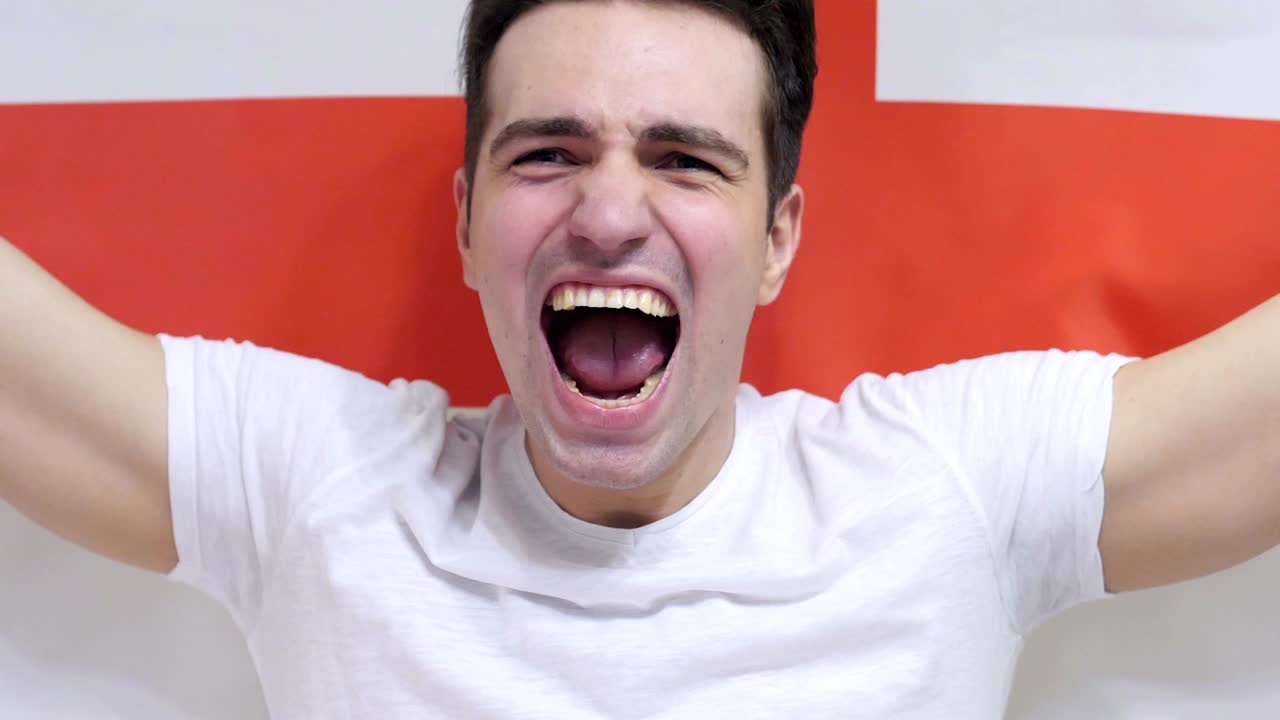 영국 젊은이가 슬로모션으로 잉글랜드의 발을 들고 축하합니다.