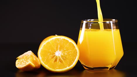 orange juice being poured into a glass