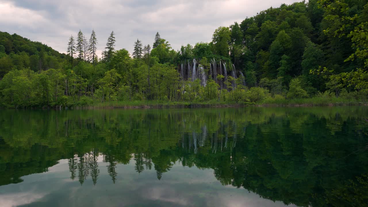 Iconic turquoise lakes at Plitvice UNESCO Park Croatia with forest, waterfalls and water reflection
